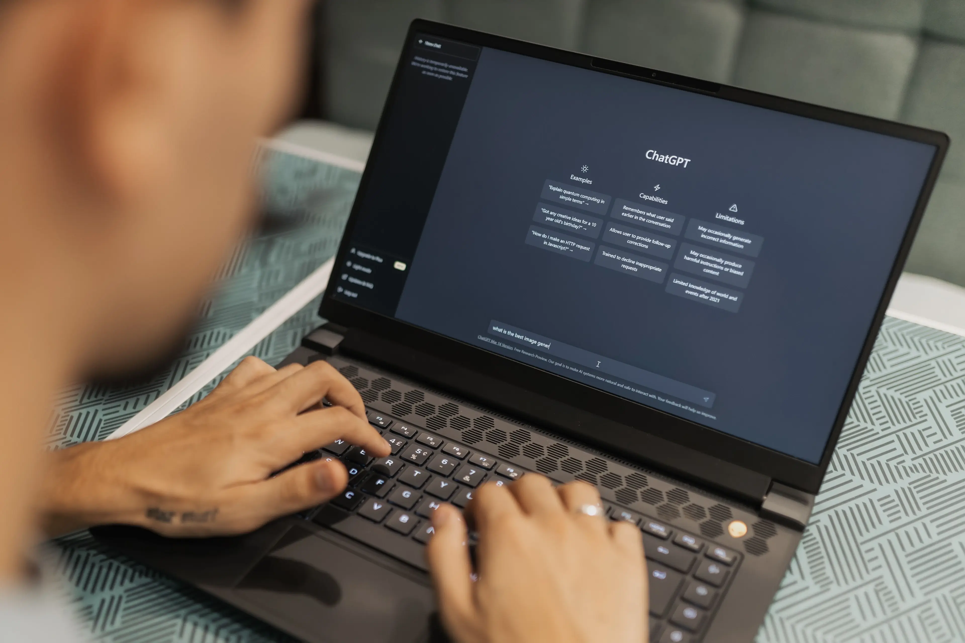 A person using ChatGPT on a laptop